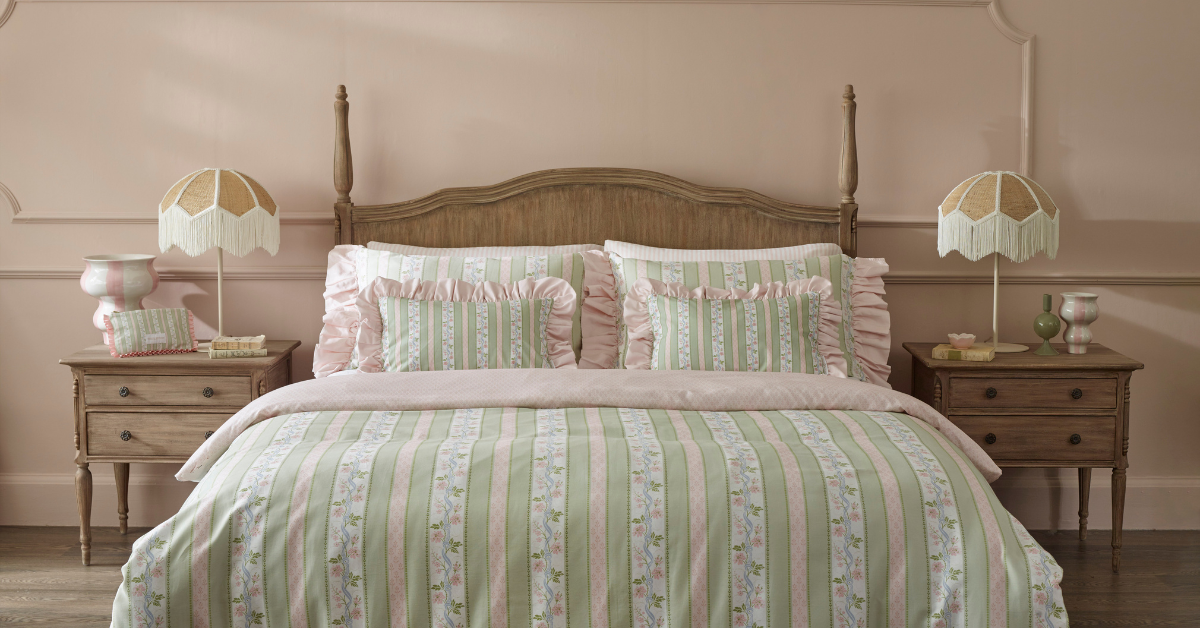 Long shot of Regency Rose bed linen set on French bed in pink room.