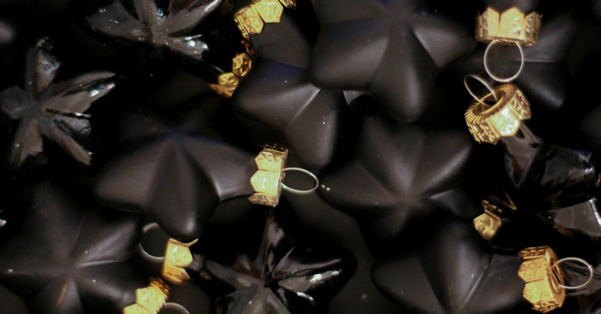 black and gold star baubles close up.